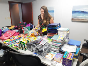 Donated school supplies are sorted in preparation for packing and distribution.